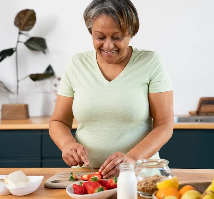 Mature woman preparing food in a bright kitchen