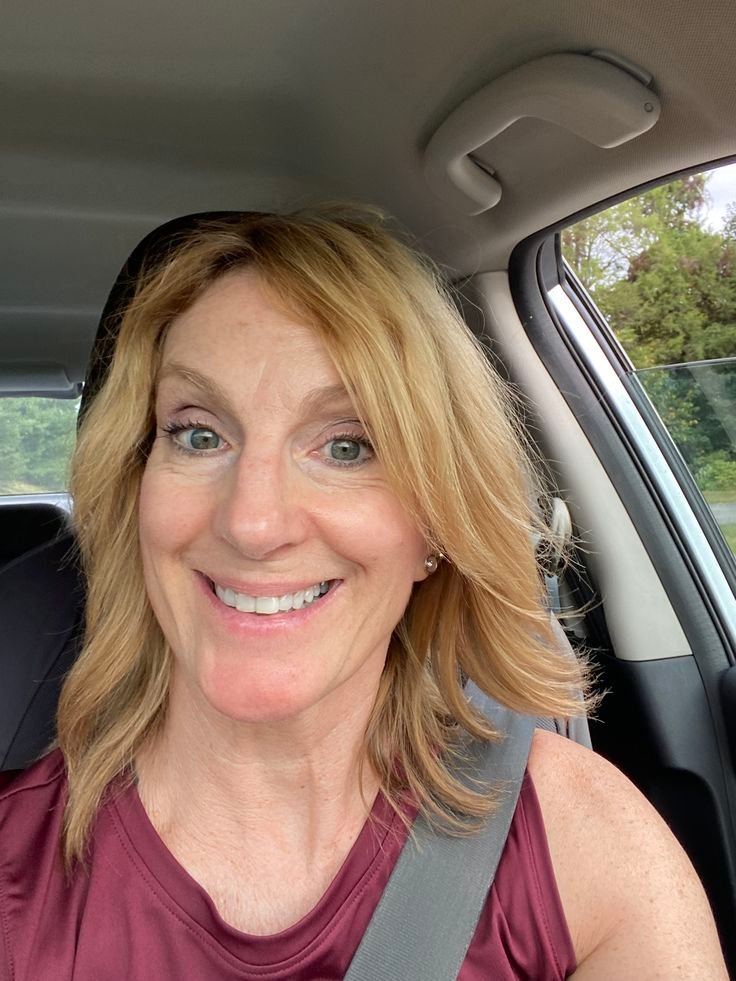 Smiling mature woman in car