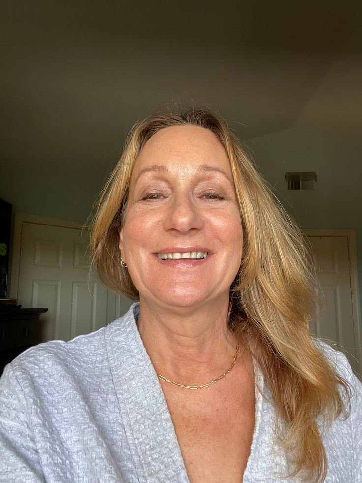 Smiling mature woman with long blonde hair